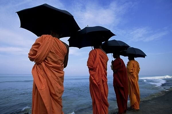 Buddhist monks watching the Indian Ocean
