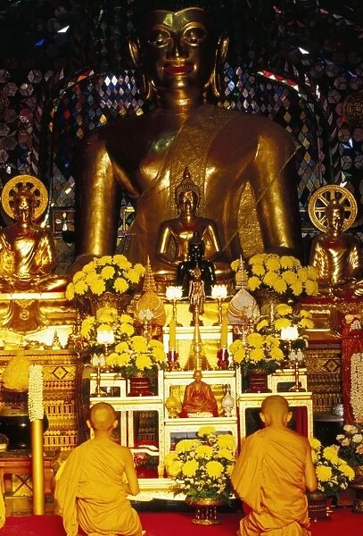 Buddhist monks worshipping inside temple