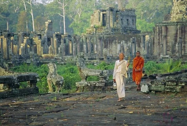 Buddhist nun and monk at the Bayon, Angkor, Siem Reap, Cambodia, Indochina, Asia