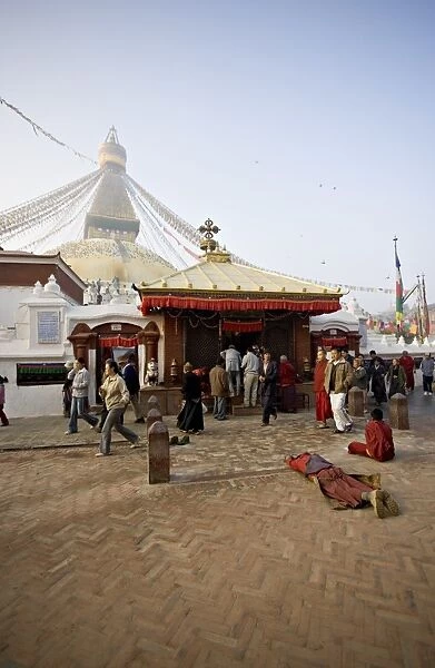 A Buddhist prostrates at dawn before the main entrance