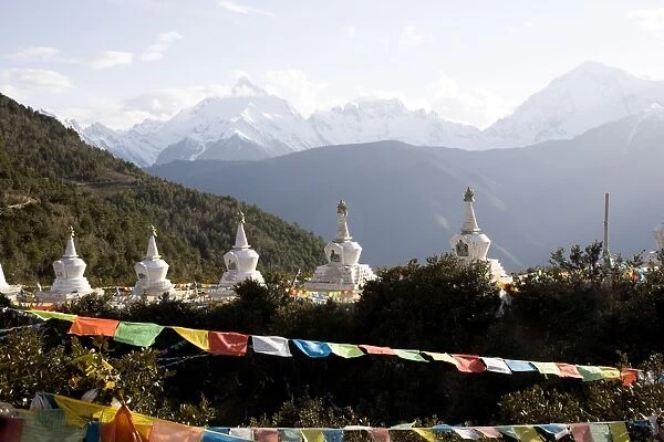 Buddhist stupas with Meili Snow Mountain peak in background, en route to the Tibetan border