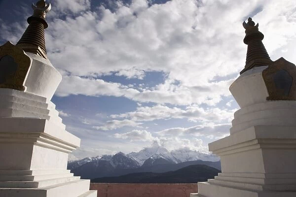 Buddhist stupas on way to Deqin, on the Tibetan Border, with the Meili Snow Mountain peak in the background, Shangri-La region, Yunnan Province