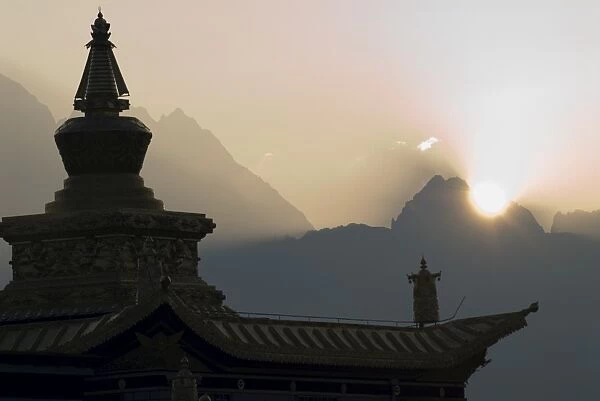 Buddhist temple at dawn with mountains beyond, Snow mountain, Tagong Grasslands
