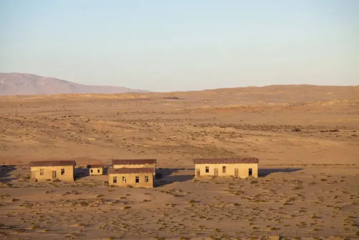 Framed Print : Buildings in the abandoned former German diamond mining town of Kolmanskop on the edge of the Namib Desert, Forbidden Diamond Area near Luderitz, Namibia