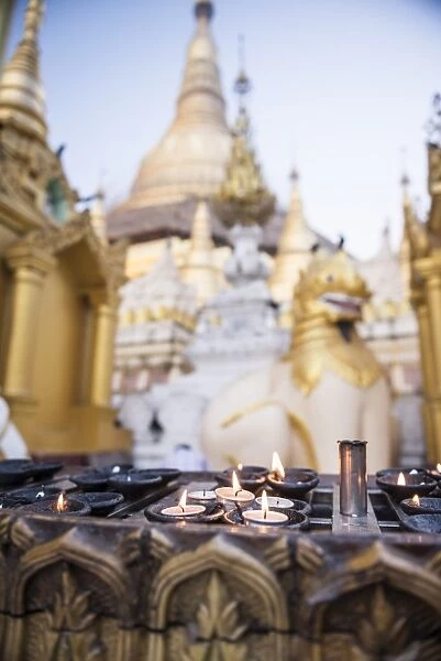 Burning candles at Shwedagon Pagoda (Shwedagon Zedi Daw) (Golden Pagoda), Yangon (Rangoon)