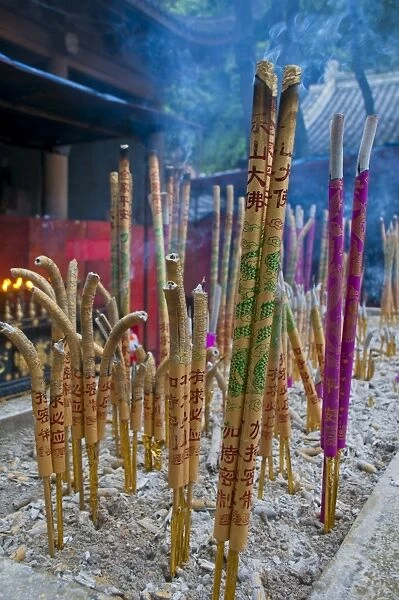 Burning sticks of Tibetan incense in a monastery above the giant Buddha of Leshan