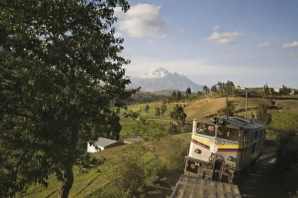 Bus and the famous El Nariz del Diablo (The Devils Nose) train en route to Riobamba with Chimborazo volcano in the distance, Riobamba, Chimborazo Province, Central Highlands, Ecuador