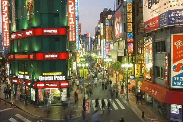 Busy streets and neon signs in the evening at Shinjuku station