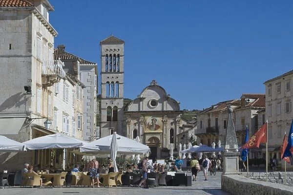 Cafes in the main square with St. Stephens Cathedral in the medieval city of Hvar, Island of Hvar, Dalmatia, Croatia, Europe