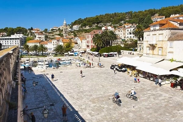 Cafes and tourists in St. Stephens Square, Hvar Town, Hvar Island, Dalmatian Coast, Croatia, Europe