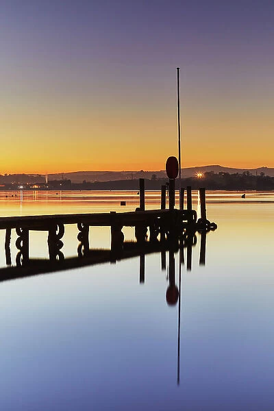 A very calm dusk scene, with a wooden jetty on the estuary of the River Teign, at Coombe Cellars, near Newton Abbot, south coast of Devon, England, United Kingdom, Europe
