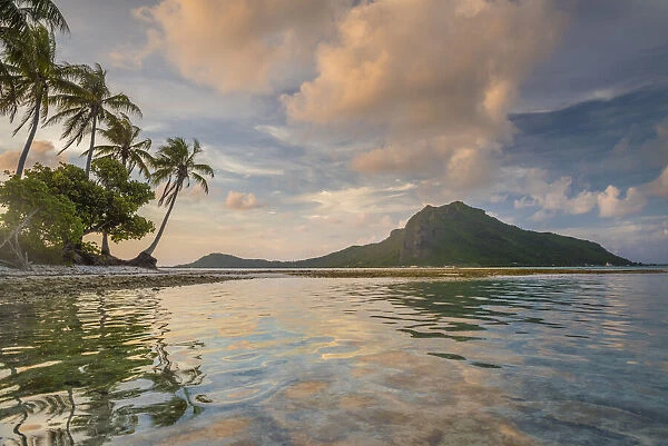 A calm evening in the lagoon of Bora Bora as a cloud forms on top of the mountain