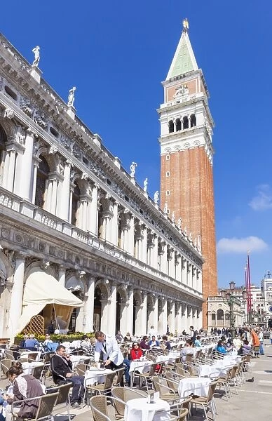 Campanile tower, Piazzetta, and tourists enjoying the cafes of St. Marks Square, Venice