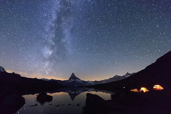 Camping under the stars and Milky Way with Matterhorn reflected in Lake Stellisee