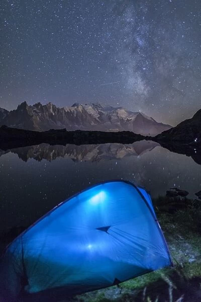 Camping with a tent under the Milky Way at Lac des Cheserys, looking at Mont Blanc