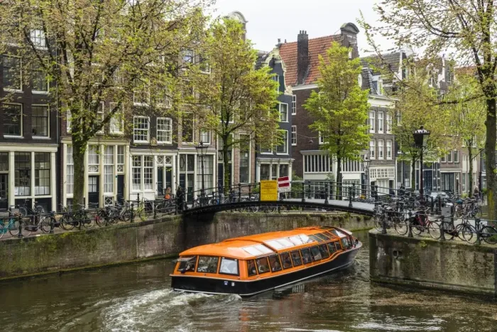 Framed Print : Canal boat passing under a bridge on Brouwersgracht, Amsterdam, Netherlands, Europe Framed Print : Canal boat passing under a bridge on Brouwersgracht, Amsterdam, Netherlands, Europe