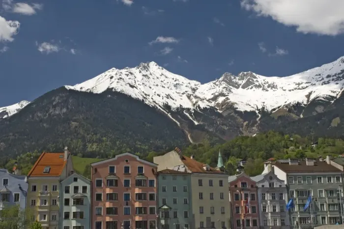Framed Print : Candy coloured houses with backdrop of mountains in spring snow, Innsbruck Framed Print : Candy coloured houses with backdrop of mountains in spring snow, Innsbruck