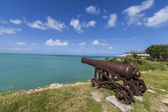 Framed Print : A cannon dating from the 17th century stands guard at Fort James one of the most Framed Print : A cannon dating from the 17th century stands guard at Fort James one of the most