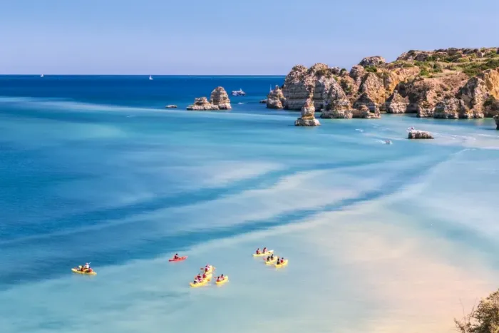 Framed Print : Canoes in the turquoise water of the Atlantic Ocean surrounding Praia Dona Ana beach Framed Print : Canoes in the turquoise water of the Atlantic Ocean surrounding Praia Dona Ana beach