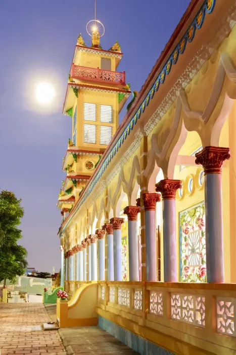Framed Print : The Cao Dai temple in Vung Tau lit up at dusk with the full moon to the left of the tower Framed Print : The Cao Dai temple in Vung Tau lit up at dusk with the full moon to the left of the tower