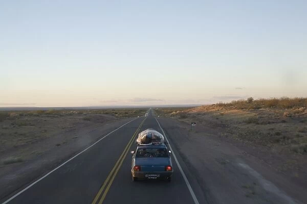 Car driving through the Pampa, Argentina, South America