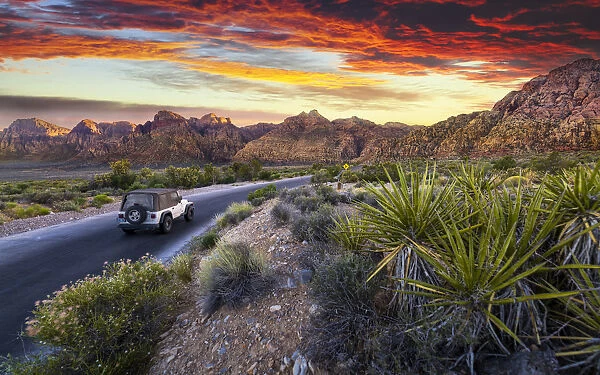 Car driving through The Red Rock Canyon National Recreation Area at sunset, Las Vegas