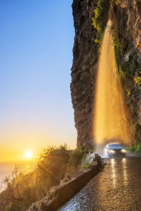 Framed Print : Car passing under Anjos waterfall on slippery coastal road at sunset, Ponta do Sol Framed Print : Car passing under Anjos waterfall on slippery coastal road at sunset, Ponta do Sol