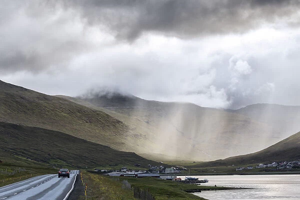 Car on road to Hvalvik, Streymoy Island, Faroe Islands, Denmark, Europe