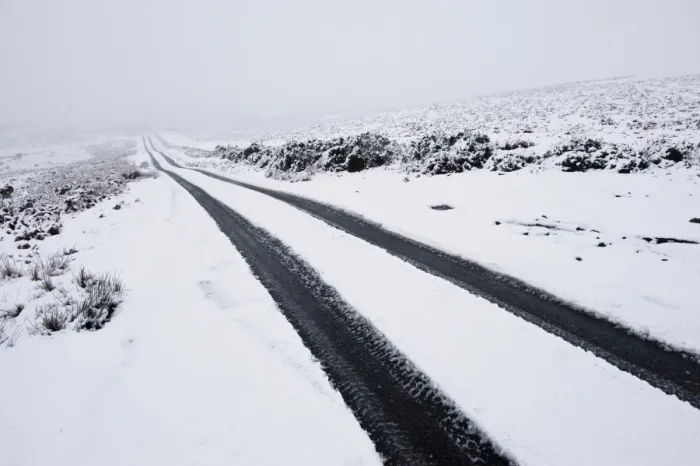 Framed Print : Car tyre tracks on a snowy road on the Mynydd Epynt moorland, Powys, Wales, United Kingdom