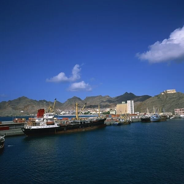 Cargo ships in port, with the town and mountains in the background, Mindelo