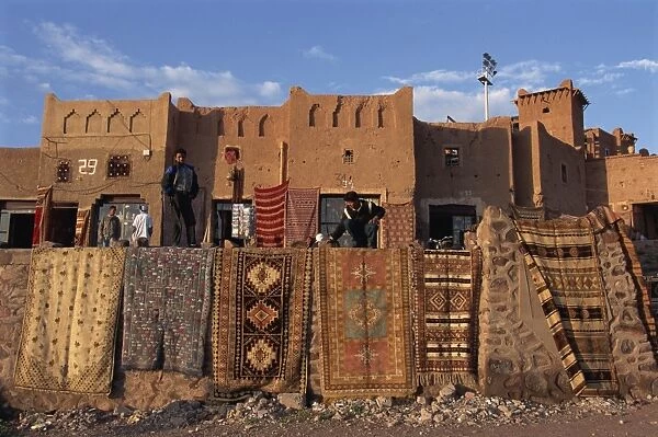 Carpets and rugs displayed on walls outdoors for sale