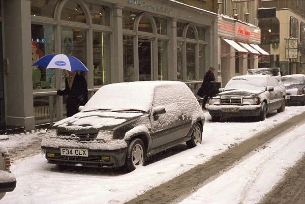 Cars covered in snow in winter on a London street, England, United Kingdom, Europe