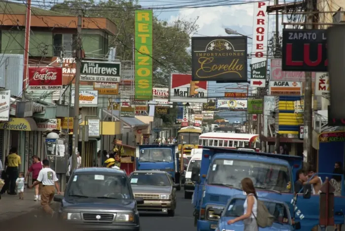Framed Print : Cars and signs in main street, Heredia, Central Valley, Costa Rica, Central America Framed Print : Cars and signs in main street, Heredia, Central Valley, Costa Rica, Central America