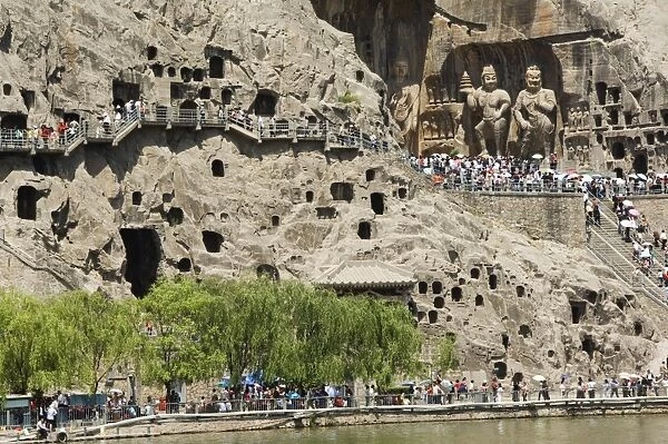 Carved Buddha images at Longmen Caves, Dragon Gate Grottoes, on the Yi He River dating from the 6th to 8th Centuries, UNESCO World Heritage Site, Henan Province