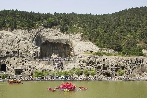 Carved Buddha images at Longmen Caves, Dragon Gate Grottoes, on the Yi He River dating from the 6th to 8th Centuries, UNESCO World Heritage Site, Henan Province