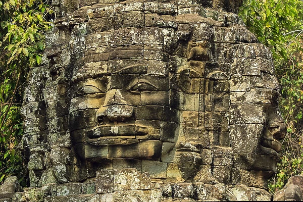 Two of four carved faces on gopura entrance way to the 12th century Banteay Kdei