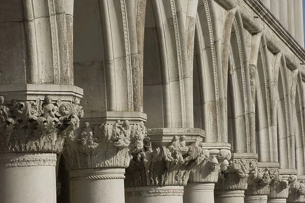 Carved stone capitals, various heads and figures, to the pillars of the Palazzo Ducale