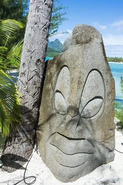 Carved stone statue on a Motu, Bora Bora, Society Islands, French Polynesia, Pacific
