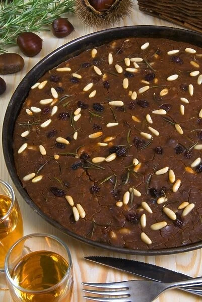 Castagnaccio, pie of chestnut flour with raisins, rosemary and pine nuts