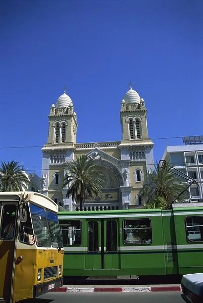 Cathedral with bus and tram in foreground