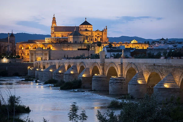 The Cathedral and Great Mosque of Cordoba (Mezquita) and Roman Bridge at twilight