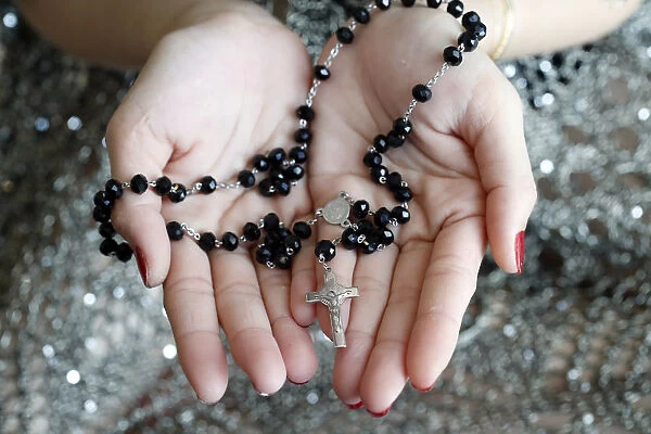 Catholic woman praying rosary beads and crucifix, Vietnam, Indochina, Southeast Asia