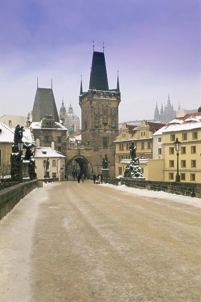 Charles Bridge and St. Vitus cathedral in winter snow, Prague, UNESCO World Heritage Site