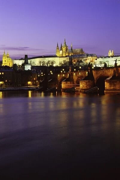 Charles Bridge, Vltava River, Mala Strana and Prague Castle at twilight during winter