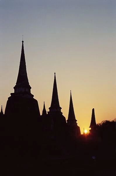 Chedis (pagodas) (stupas) in silhouette at sunset