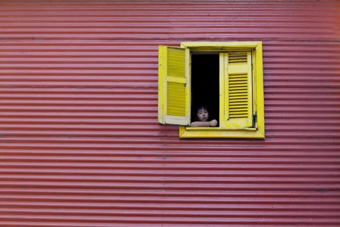 Framed Print : Child at a window, La Boca, Buenos Aires, Argentina, South America Framed Print : Child at a window, La Boca, Buenos Aires, Argentina, South America
