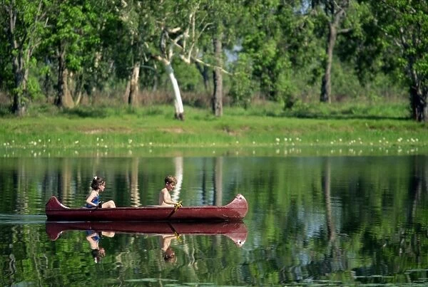 Children canoeing in Annaburroo Billabong at Mary River Crossing near the Arnhem Highway