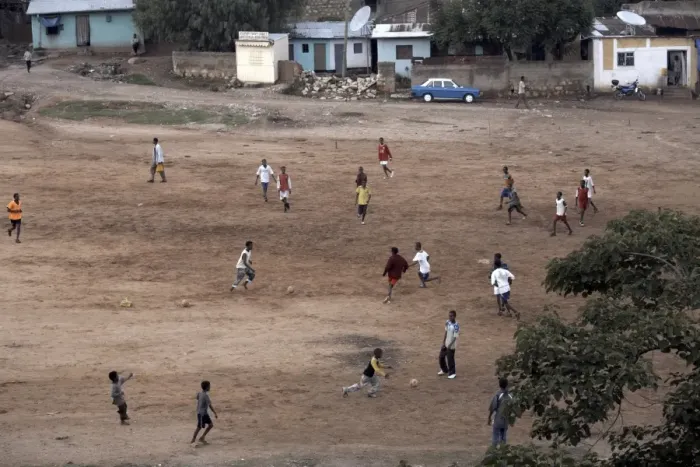 Framed Print : Children play football on a dirt pitch in Harar, Ethiopia, Africa Framed Print : Children play football on a dirt pitch in Harar, Ethiopia, Africa