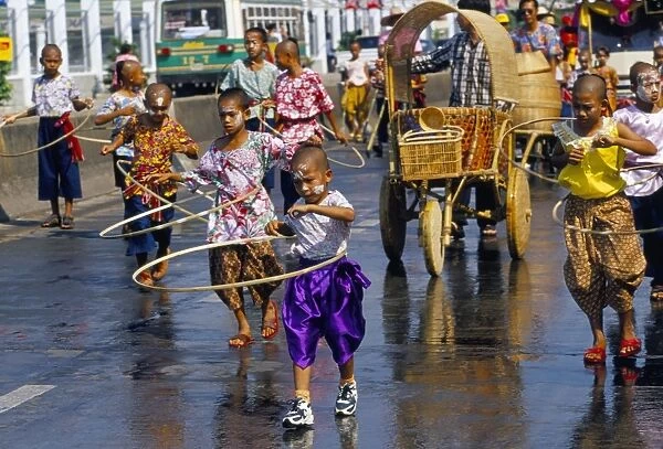 Children playing and parading in streets during King Narai Reign Fair