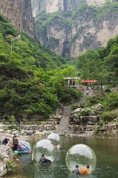 Children playing on river inflatables, Wan Xian mountain recreation area